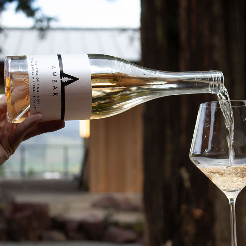 Ambar Estate rose being poured into a glass.