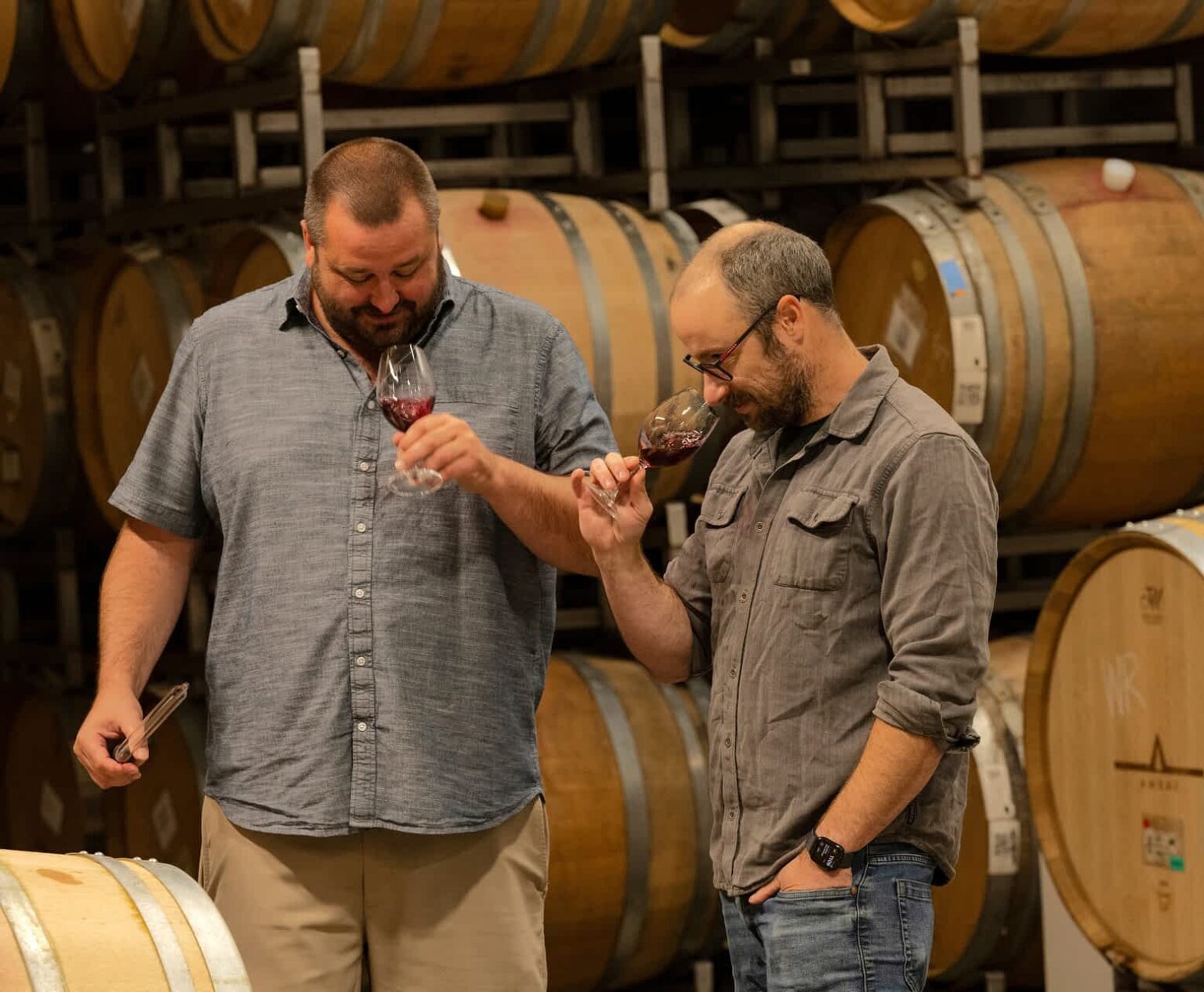 Winemakers evaluating wine in Ambar Estate's barrel room